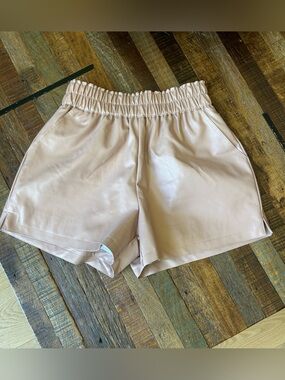 Women's Pale Pink/Blush Faux Leather Elastic Waist Shorts with pockets.